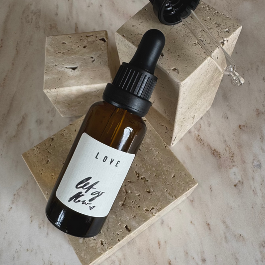 Ritualöl Liebe in braunem Fläschchen und Pipette  auf beigen Stein Display