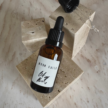 Moon child ritual oil in brown bottle with dropper on beige stone display
