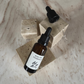 Ritual Oil Healthy Boundaries in brown bottle with Dropper on stone displays 
